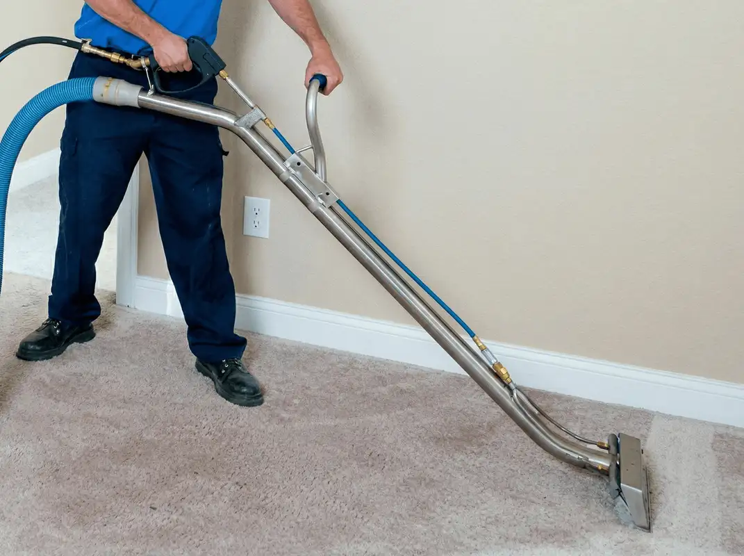 Professional operating a liquid removal machine on a carpeted floor in Syracuse, NY
